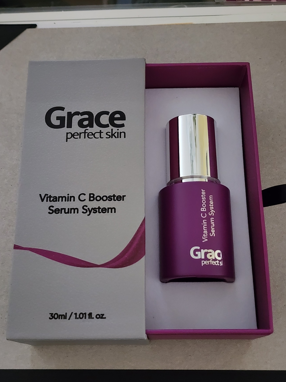 Grace Vitamin C Booster Serum in deep magenta and silver